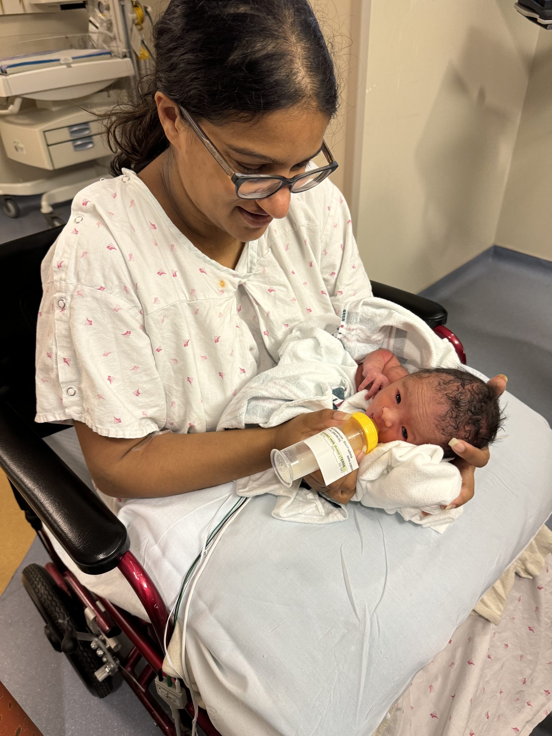 Mother feeds her baby with donor milk in hospital