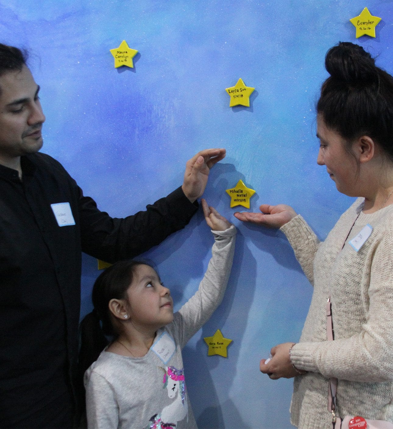 Happy family with child and star wall